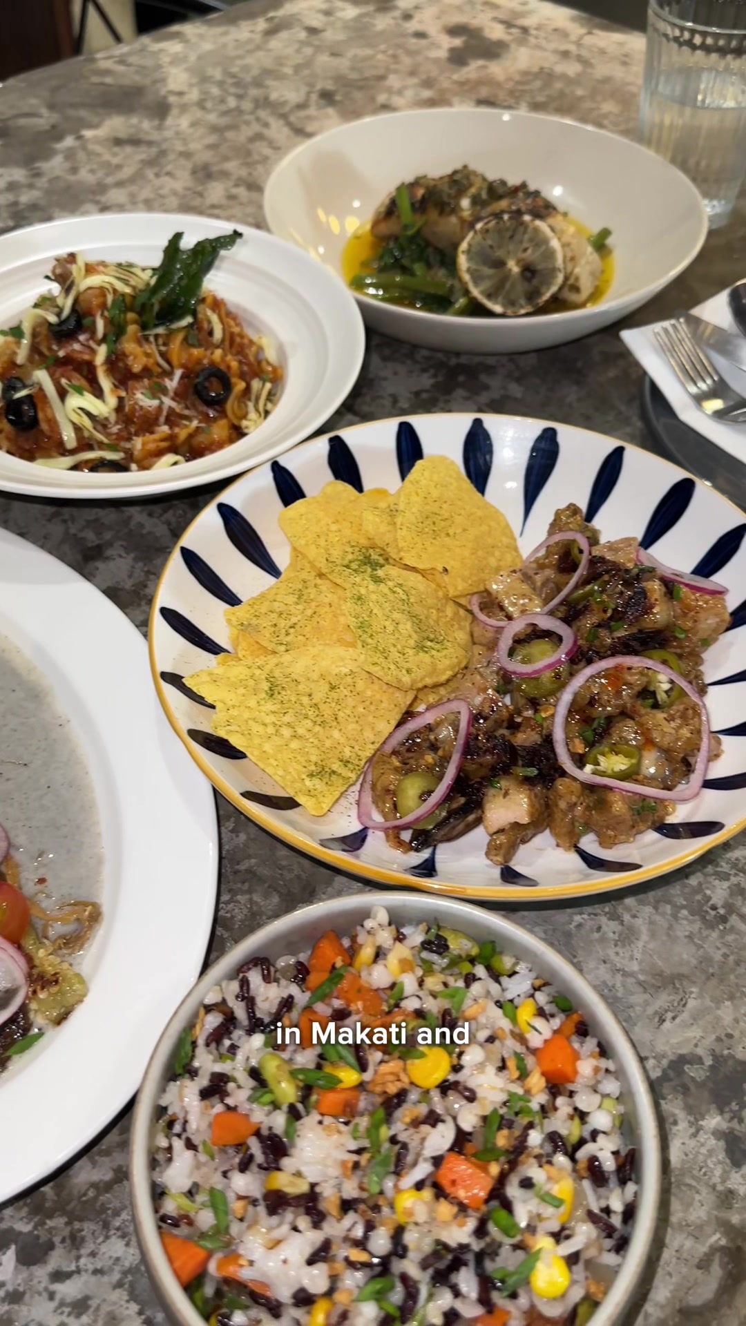 Rabbit Room food spread with Filipino-Italian dishes on marble table